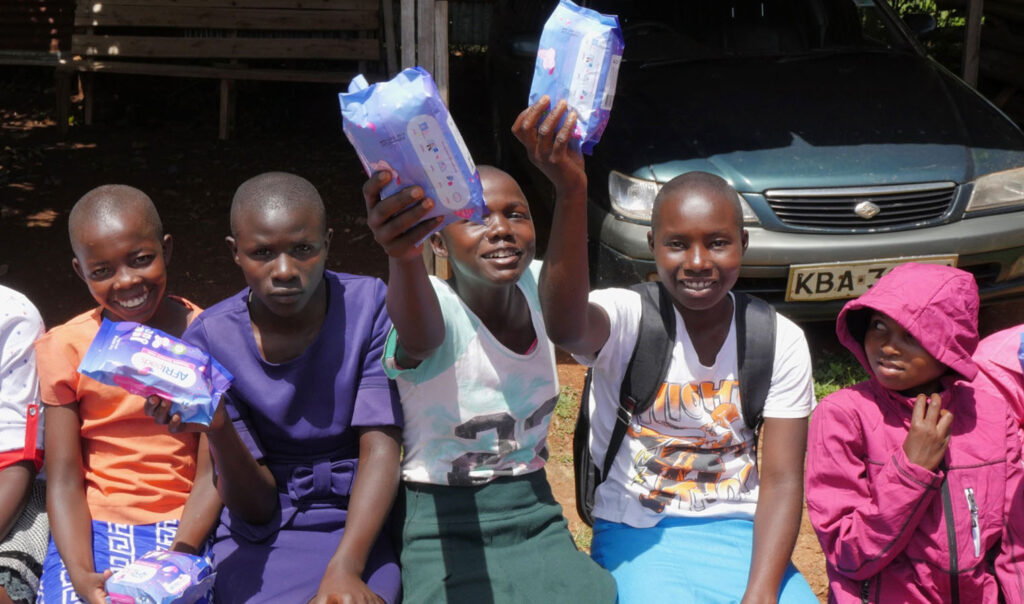 Young girls proudly displaying their Afripad kits they got from the free seminar in Rionchogu, Kenya